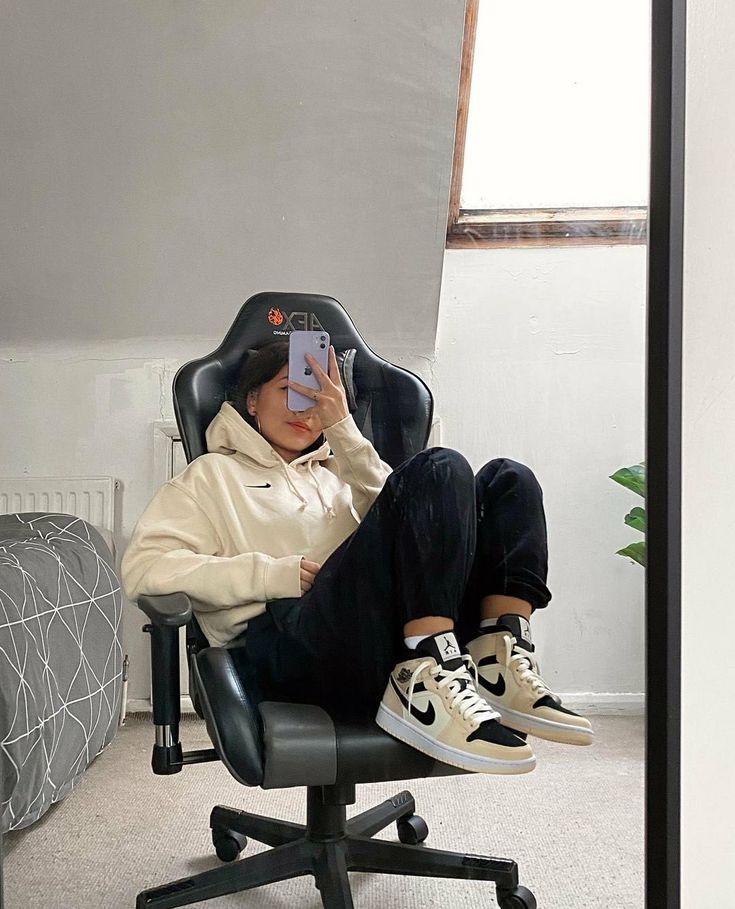 a person sitting in an office chair taking a selfie