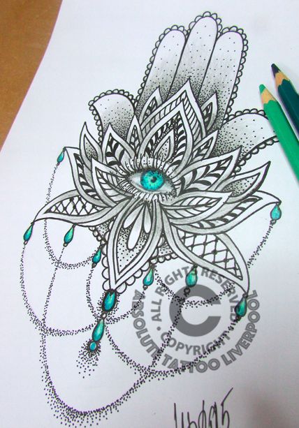 a drawing of a flower with green eyes on paper next to a pencil and marker