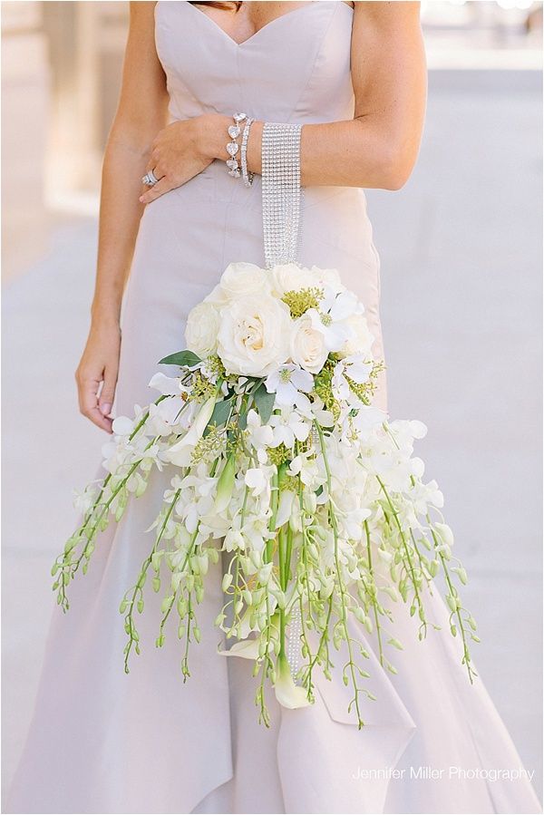 a woman in a wedding dress holding a bouquet