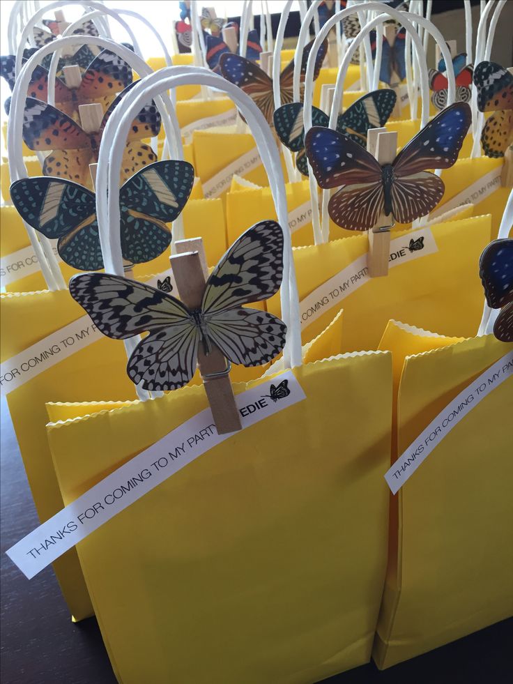 small yellow bags with butterfly decorations on them