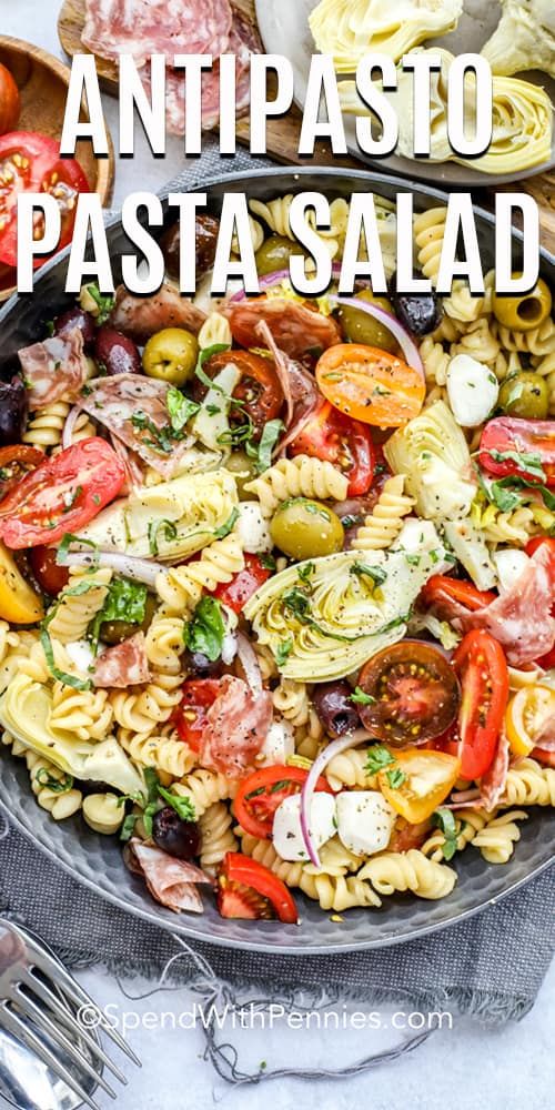 an image of pasta salad with tomatoes and olives