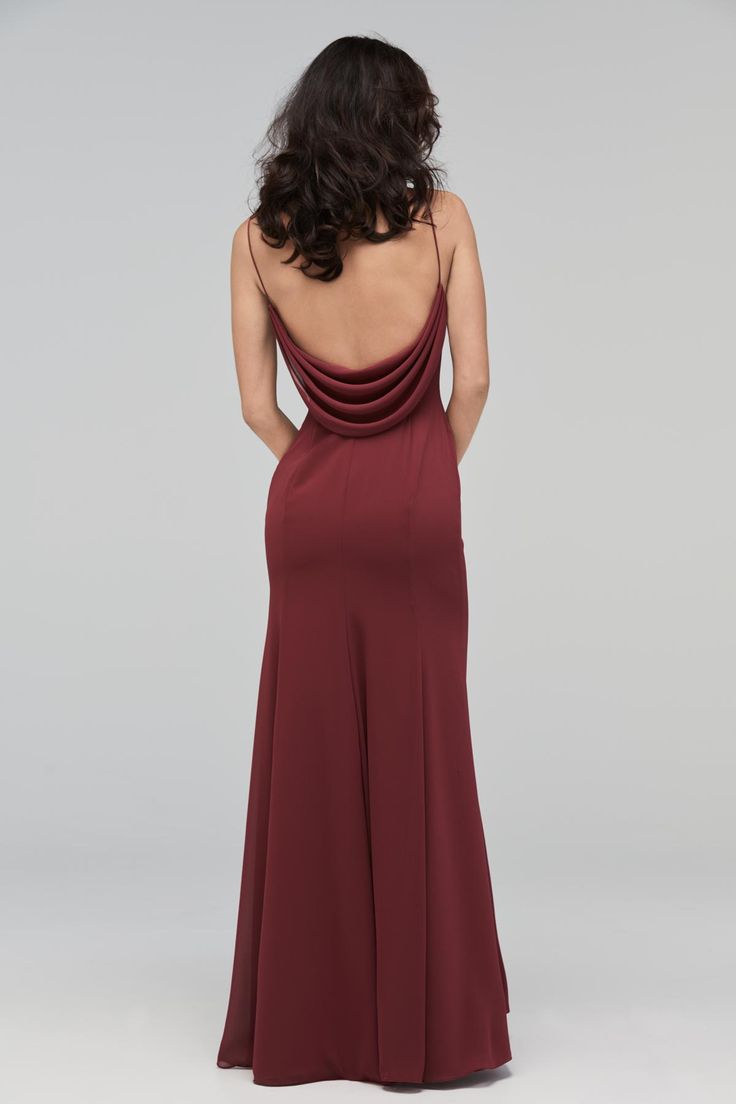 the back of a woman wearing a long, burgundy dress with an open neckline