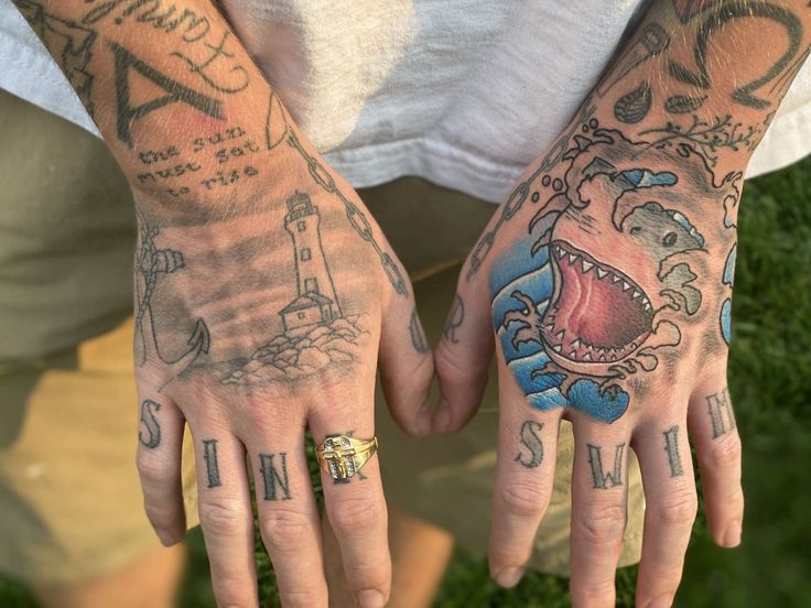 two people with tattoos on their hands and one has an open mouth in the middle