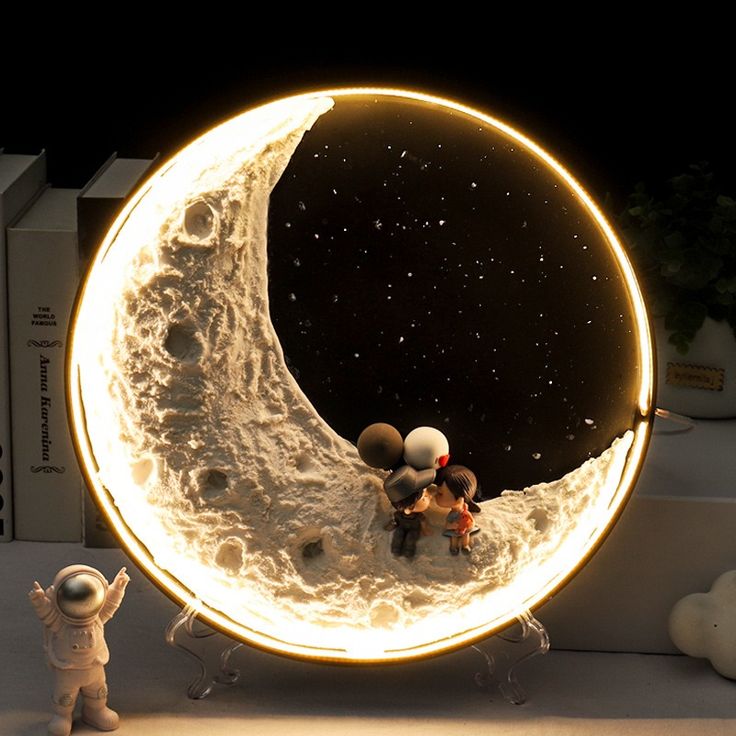 an image of two people sitting on the moon in front of books and stuffed animals