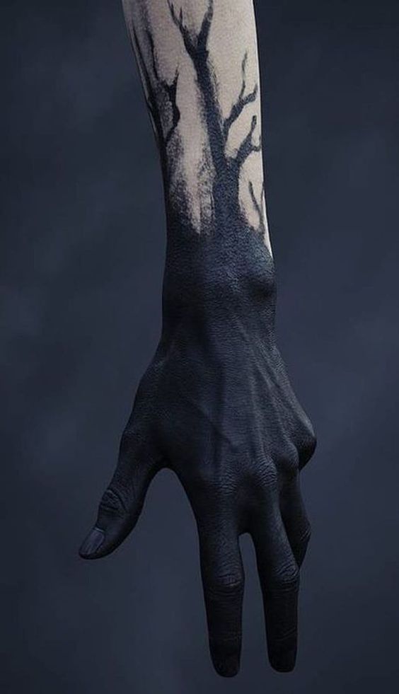 a person's hand with a tree painted on the arm and wrist, against a dark background