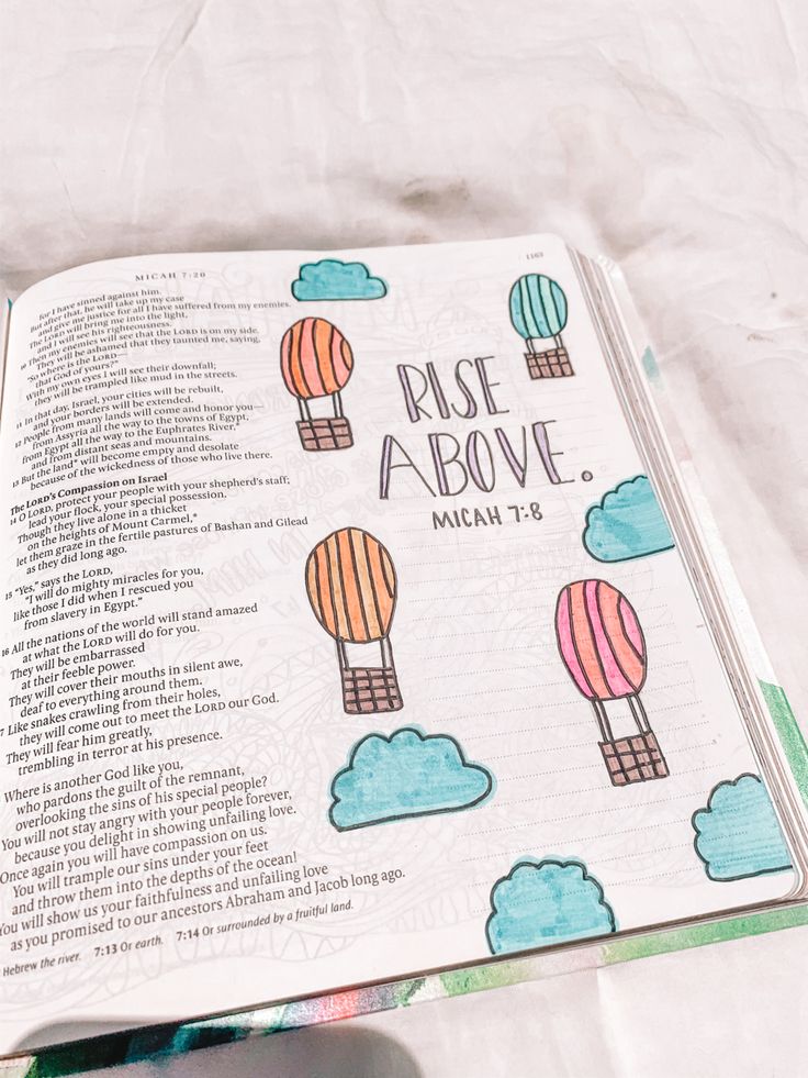 an open bible with hot air balloons on it