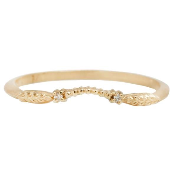 a gold ring with two diamonds on it