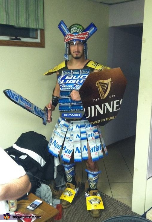 a man dressed up like a knight holding two beer bottles in his hands and standing next to him