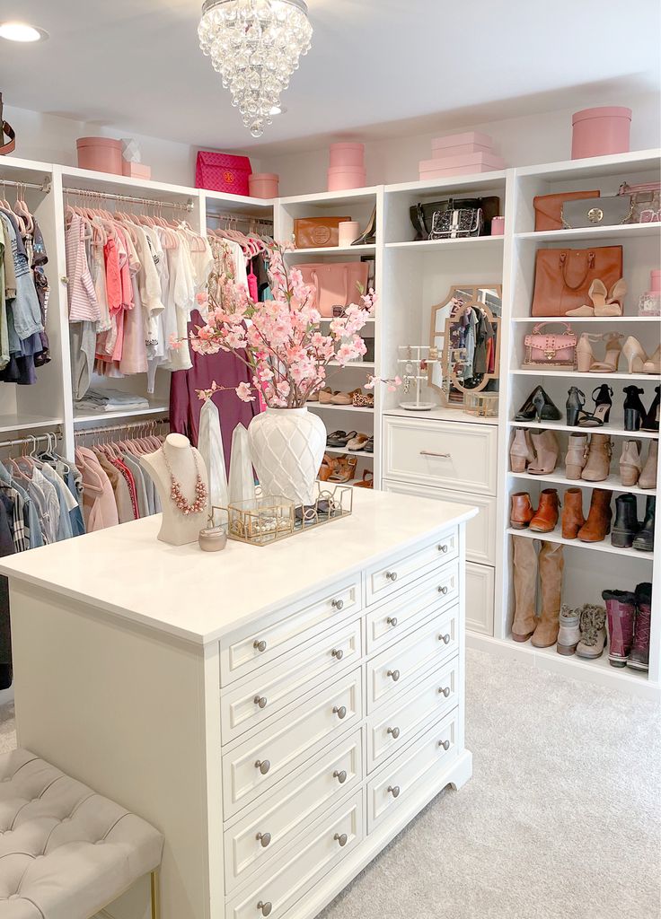 a closet with white drawers and shelves filled with shoes