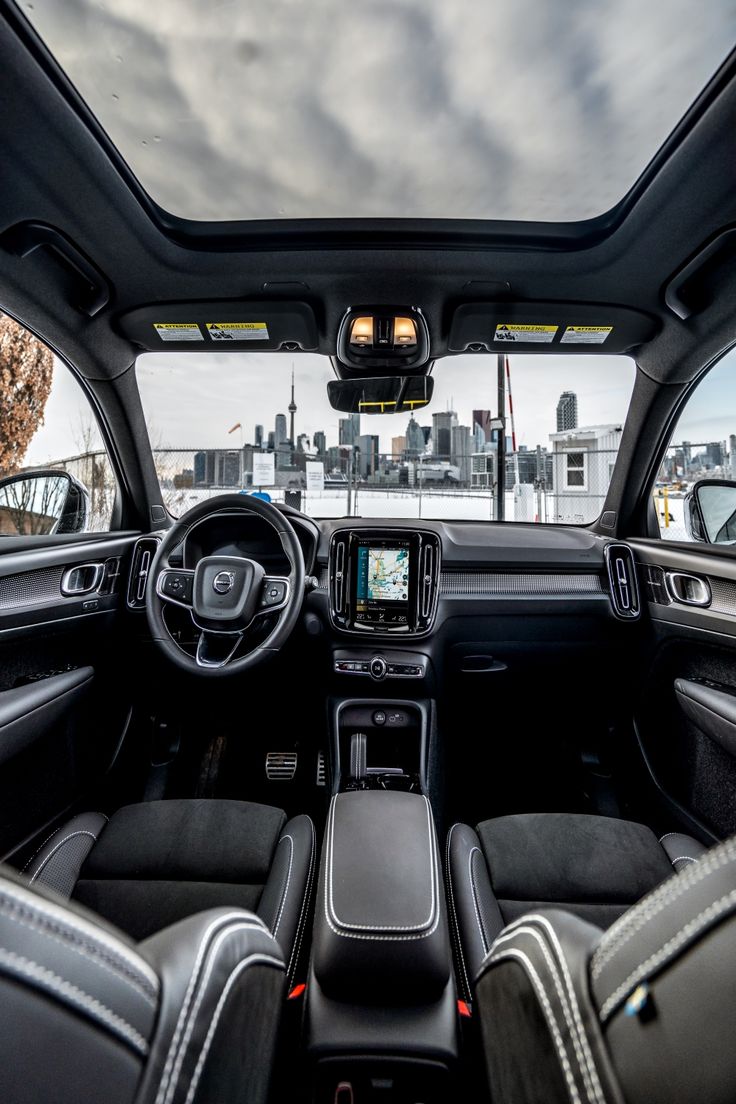 the interior of a car with its dashboard and dash lights on, as seen from the driver's seat