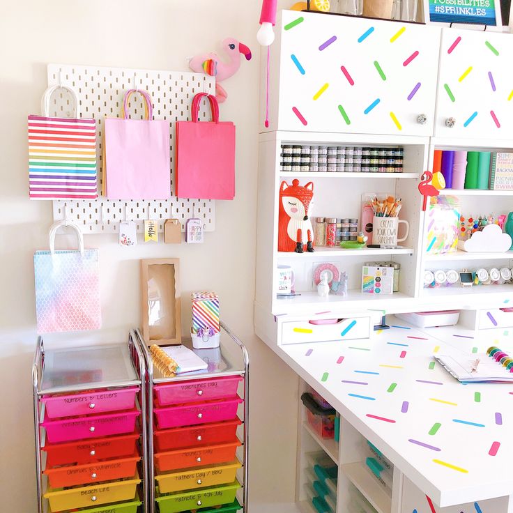 an organized craft room with lots of colorful drawers