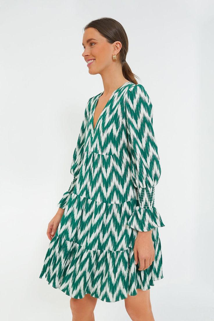 A Tuckernuck fan favorite, the Green Ikat Kenzo Dress is the mini of the season. Featuring feminine flutter smocked cuffs, a V-neckline and a loose empire waist, this is the most flattering flirty frock! Pair with flats for a casual look or dress it up with heels and statement earrings for date night. V-neckline Long sleeves Elasticated ruffle cuff Swing shape Tiered skirt Mini length Material: 75% Rayon, 25% Nylon Care: Hand wash cold Kenzo Dress, Green Ikat, Ikat Dress, Skirt Mini, Tier Skirt, Tiered Skirt, Shoulder Length, Empire Waist, Green Dress