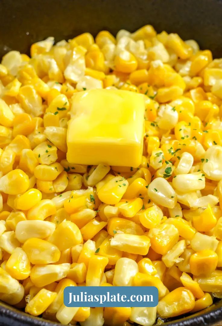 corn and butter in a skillet with the words juliasplate com on it