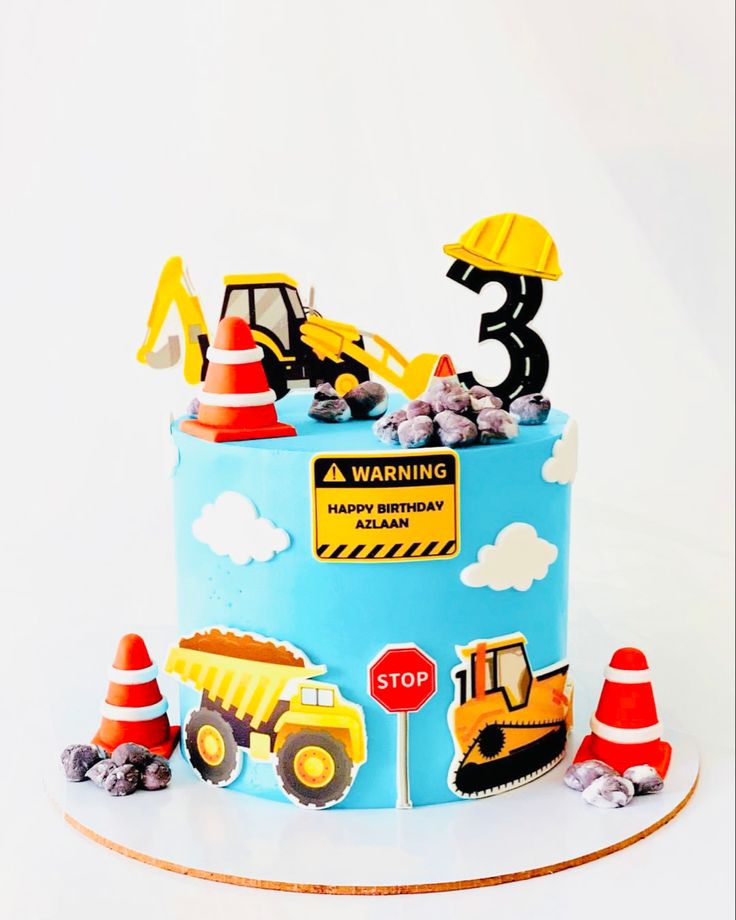 a birthday cake with construction vehicles on it