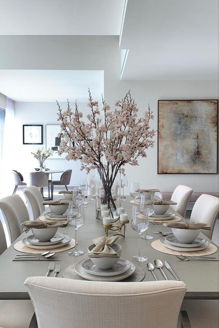 the dining room table is set with white dishes and place settings for eight people to eat