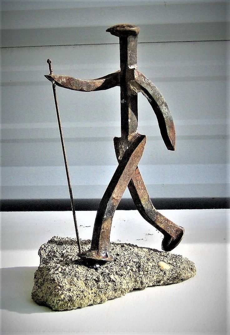 a sculpture of a man walking with a cane