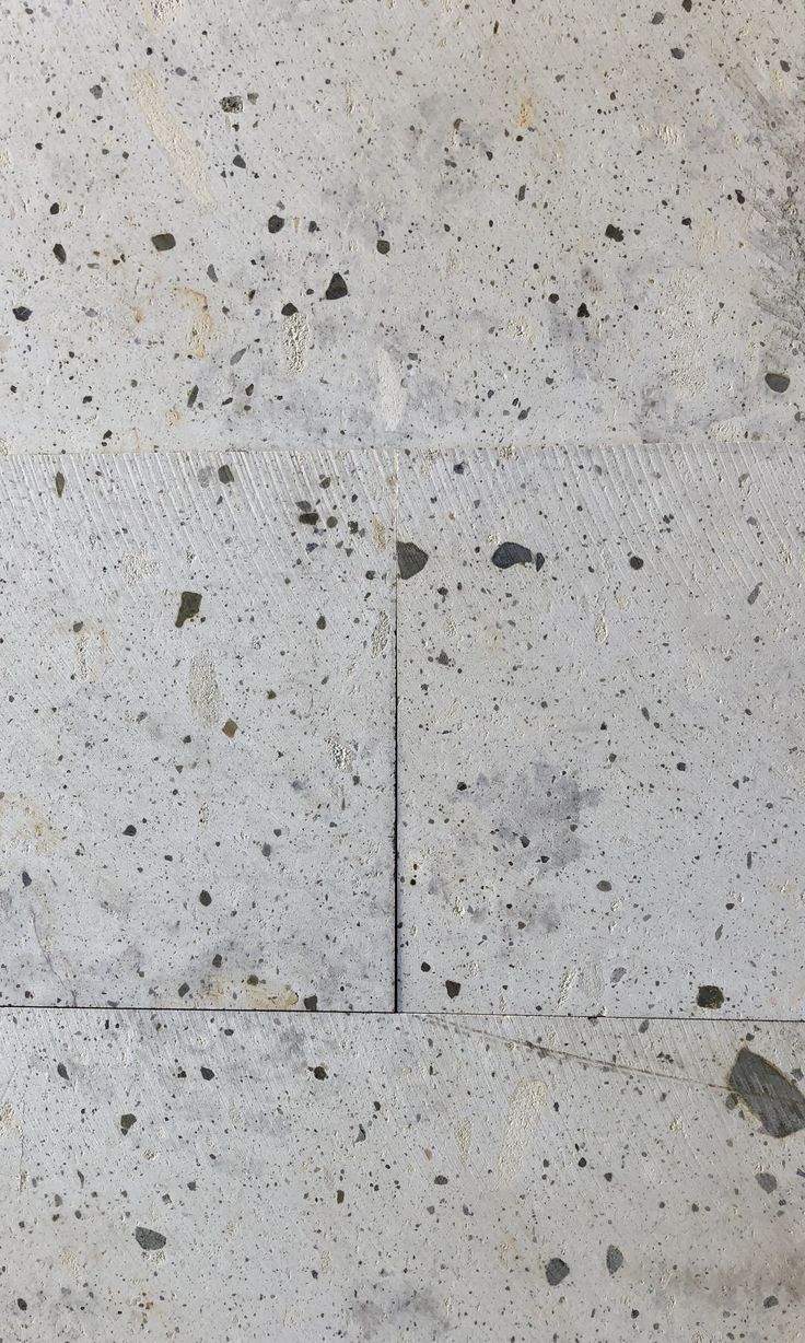 an image of concrete flooring that looks like it has little holes in the cement