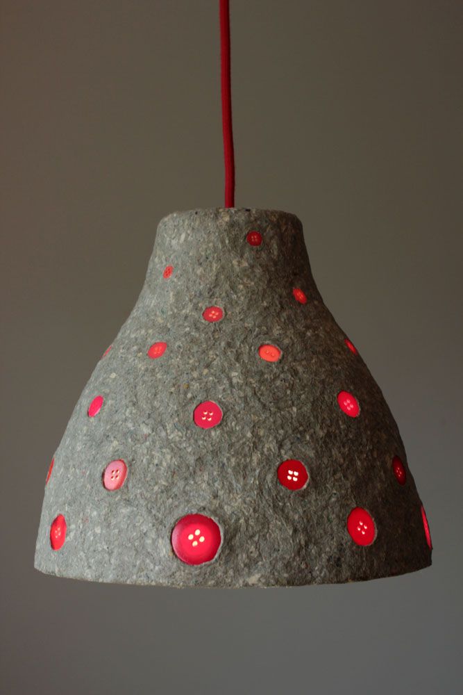 a rock lamp hanging from a red cord