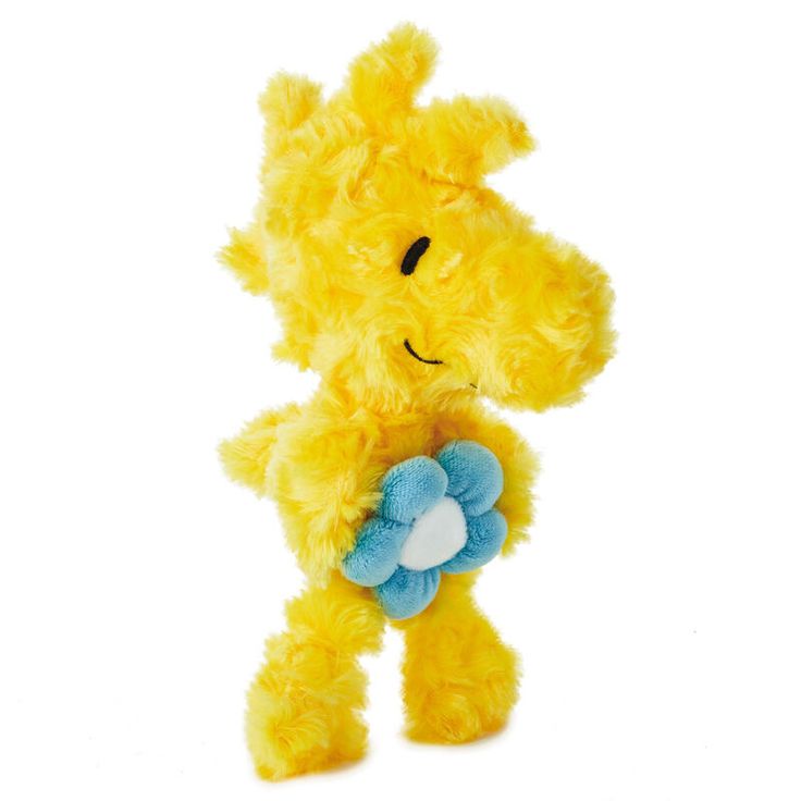 a yellow stuffed animal holding a blue flower