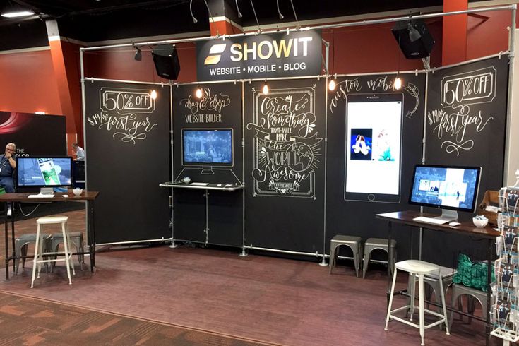 an exhibit booth with chalkboard walls and tables