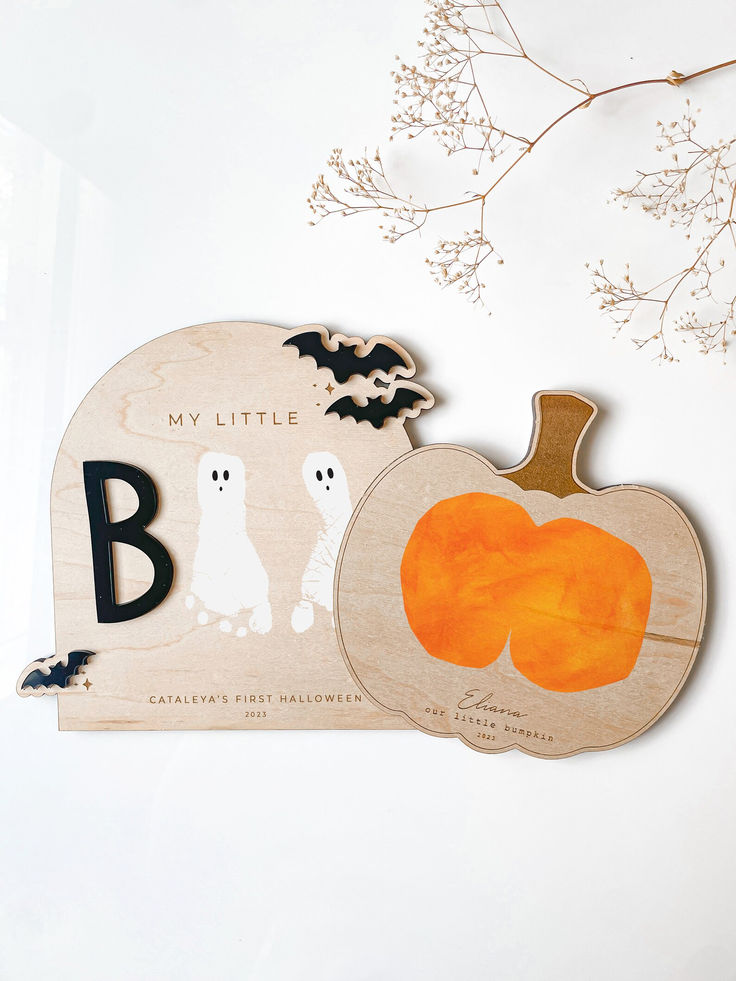 two wooden pumpkins with bats on them and the letter b is for booze