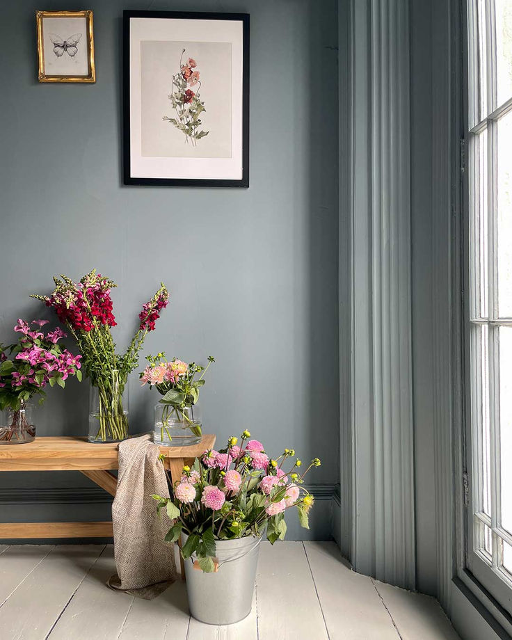 some flowers are sitting on a table in a room