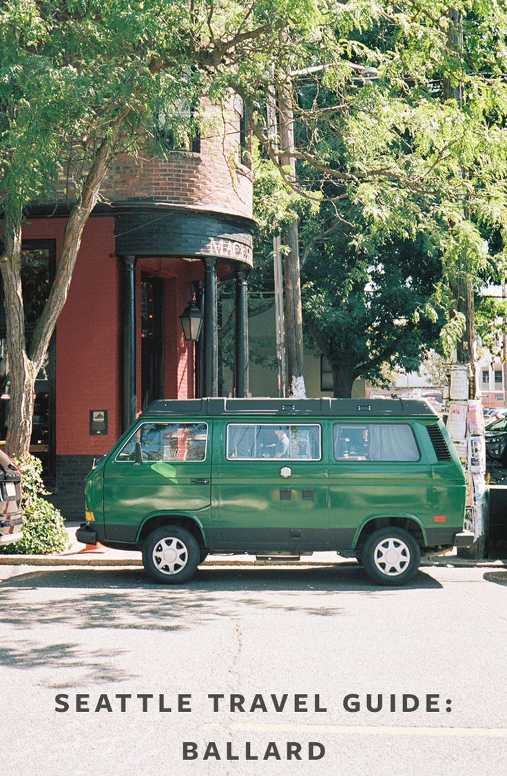 a green van parked in front of a red building with the words seattle travel guide ballard on it