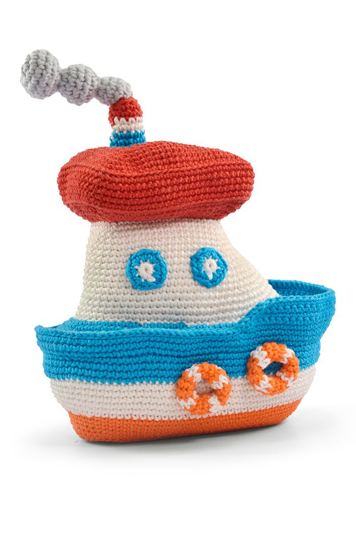 a knitted toy boat with a red hat on top