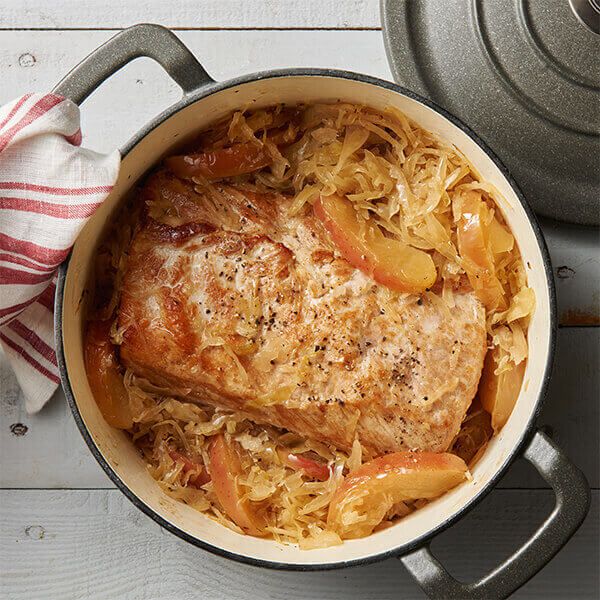 a pot filled with meat and vegetables on top of a table