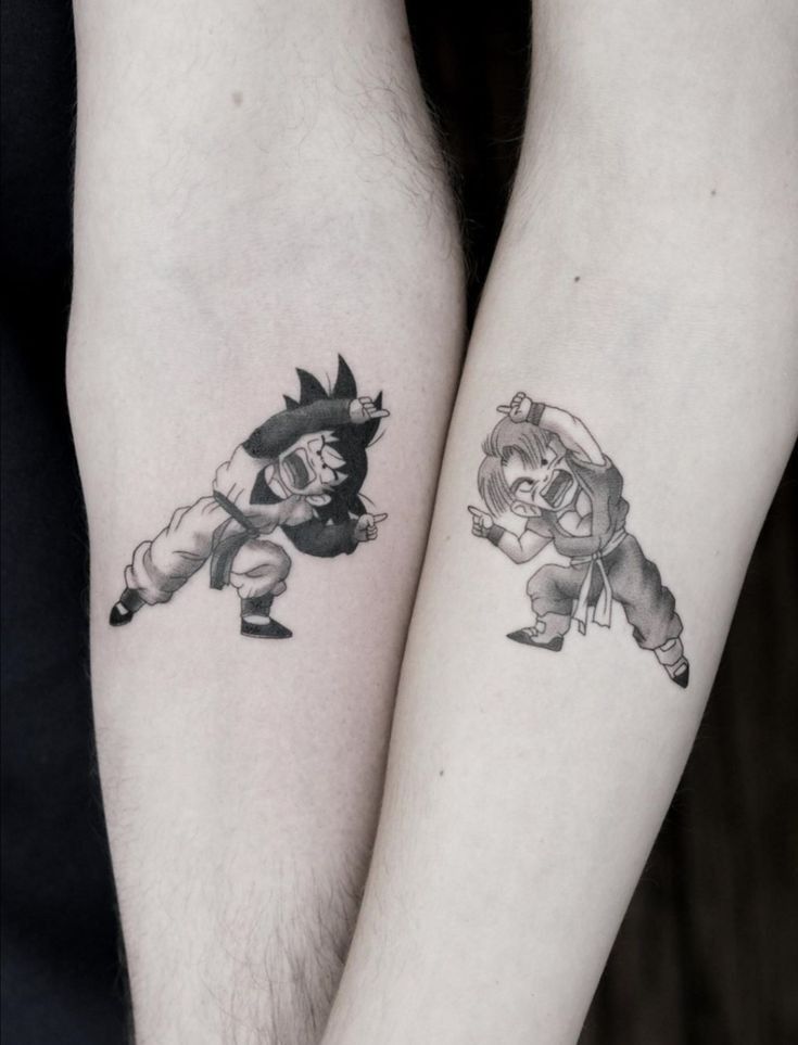 two people with tattoos on their arms