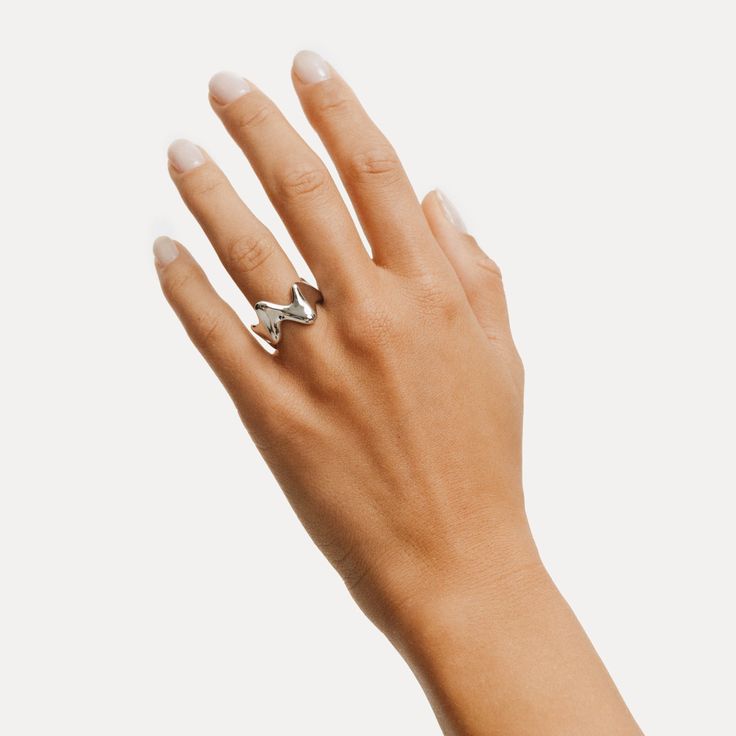 Elegant, sculptural design with flowing lines and a high-polish finish. Wear it as a solo piece that turns heads or mix it into your bold ring stack.  This wide, distinctive signet ring with its sleek, modern design makes a cool statement. The wave shape of this unique chunky silver ring will add a special, extraordinary detail to your outfit. Minimalist designer silver jewelry; designed in Berlin and made from recycled sterling silver and 18k gold vermeil. Our Sterling silver jewelry is crafted from 100% recycled Sterling silver, and features an additional layer of Rhodium plating. Rhodium is a precious metal that gives the jewelry polish and shine, making it more resistant to tarnishing and scratching.   All our pieces have the 925 stamp, showing that the base of the jewelry pieces is ma Modern Wide Band Ring With Polished Finish, Modern Open Ring With Shiny Finish, Modern Twist Open Dome Ring For Formal Occasions, Modern Twist Open Design Dome Ring For Formal Occasions, Modern Twist Formal Open Dome Ring, Modern White Gold Jewelry With Unique Design, Modern Twist Dome Ring With Polished Finish, Modern Dome Ring With Polished Finish, Sculptural Jewelry With Polished Finish For Formal Occasions