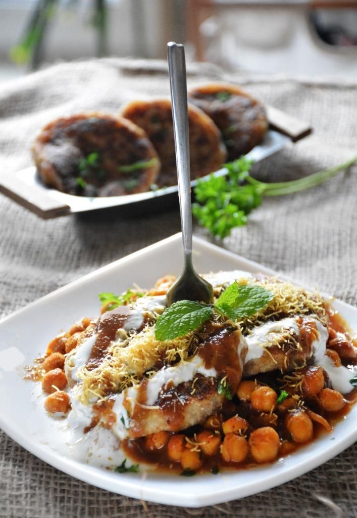 a white plate topped with meat covered in sauce and garnished with carrots