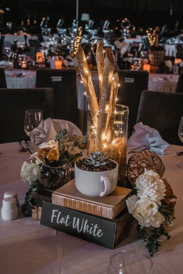 the table is set with books, flowers and candles for an elegant dinner or party