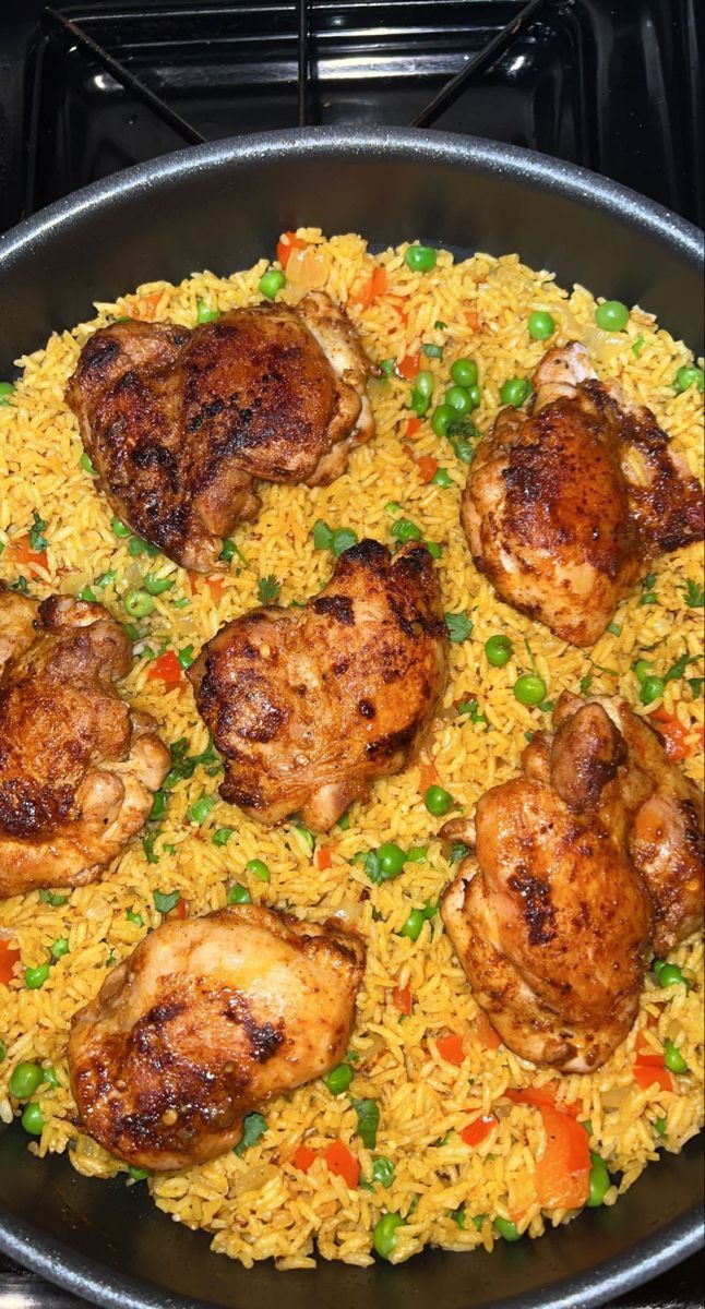 chicken and rice in a skillet on the stove top, ready to be eaten