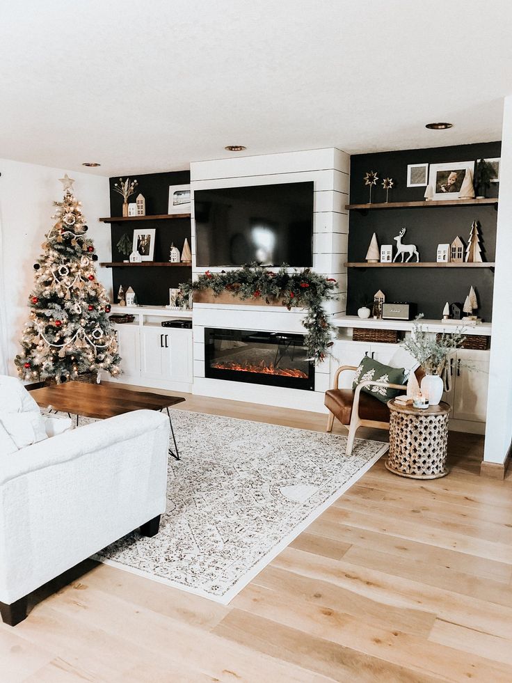 the living room is decorated for christmas with white furniture and decorations on the fireplace mantel