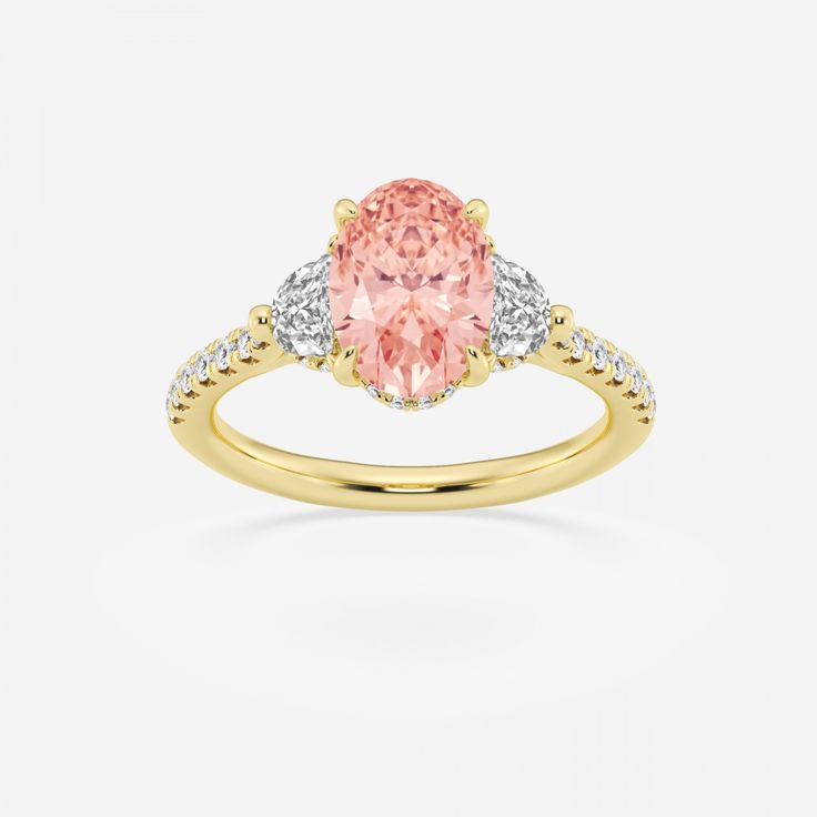 a yellow gold ring with an oval pink diamond and two white diamonds on the band