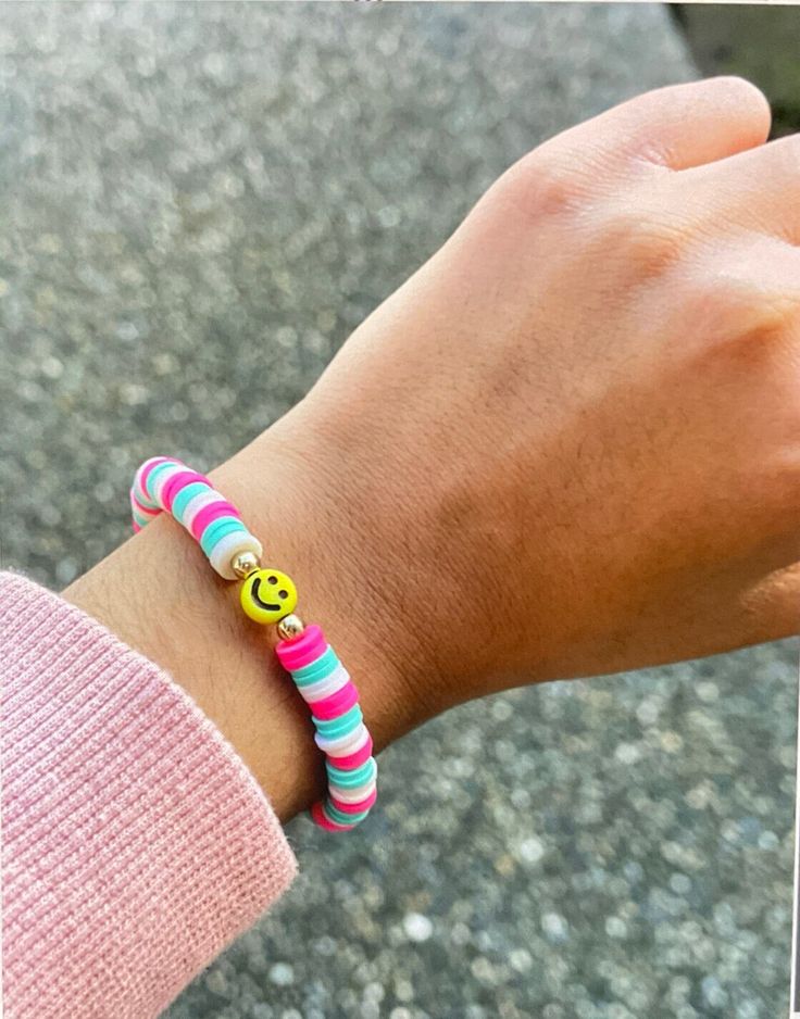 It's a preppy smiley pink and blue bracelet that's made with love. Cheerful Adjustable Multicolor Friendship Bracelets, Cheerful Multicolor Adjustable Friendship Bracelets, Trendy Multicolor Friendship Bracelets, Colorful Fun Friendship Bracelets, Playful Colorful Beaded Friendship Bracelets, Playful Colorful Bracelets For Everyday, Fun Multicolor Everyday Bracelets, Playful Friendship Bracelets, Fun Beaded Bracelets For Everyday Summer Wear