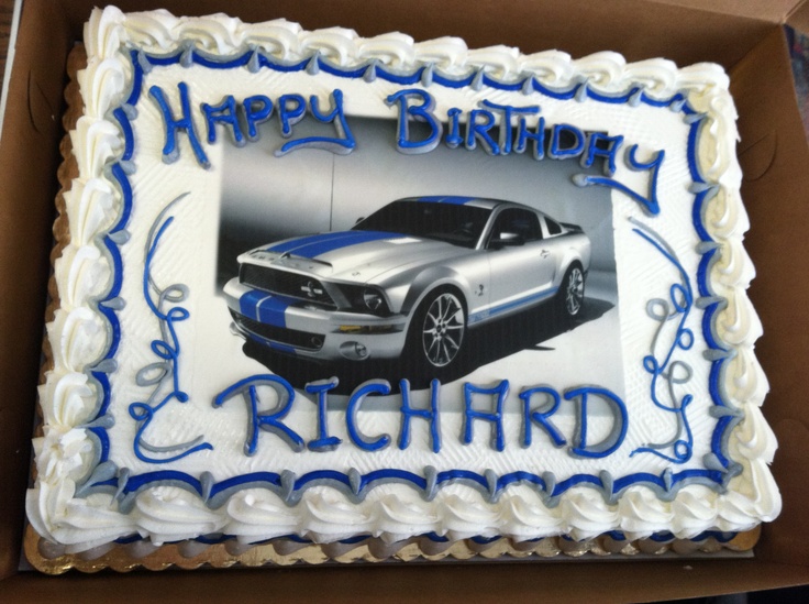 a birthday cake with a photo of a mustang car on the front and blue stripes