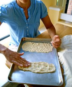 a woman holding a pan with some food on it