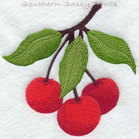 three cherries on a branch with green leaves embroidered onto the back of a white towel