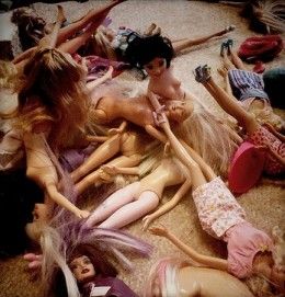 a group of naked dolls laying on the floor