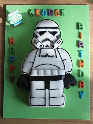 a star wars themed birthday cake with a storm trooper on it's face and name