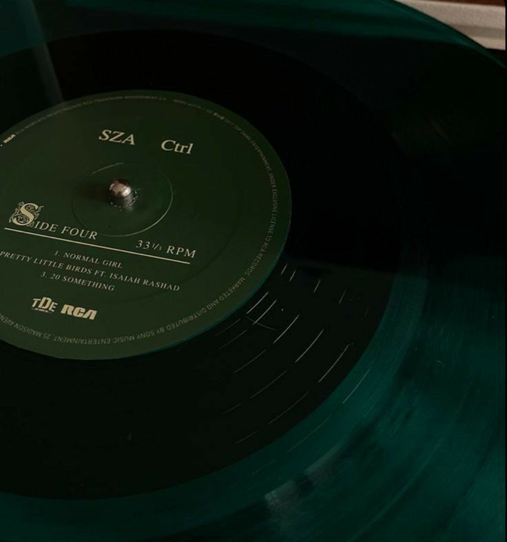 a green vinyl record sitting on top of a table