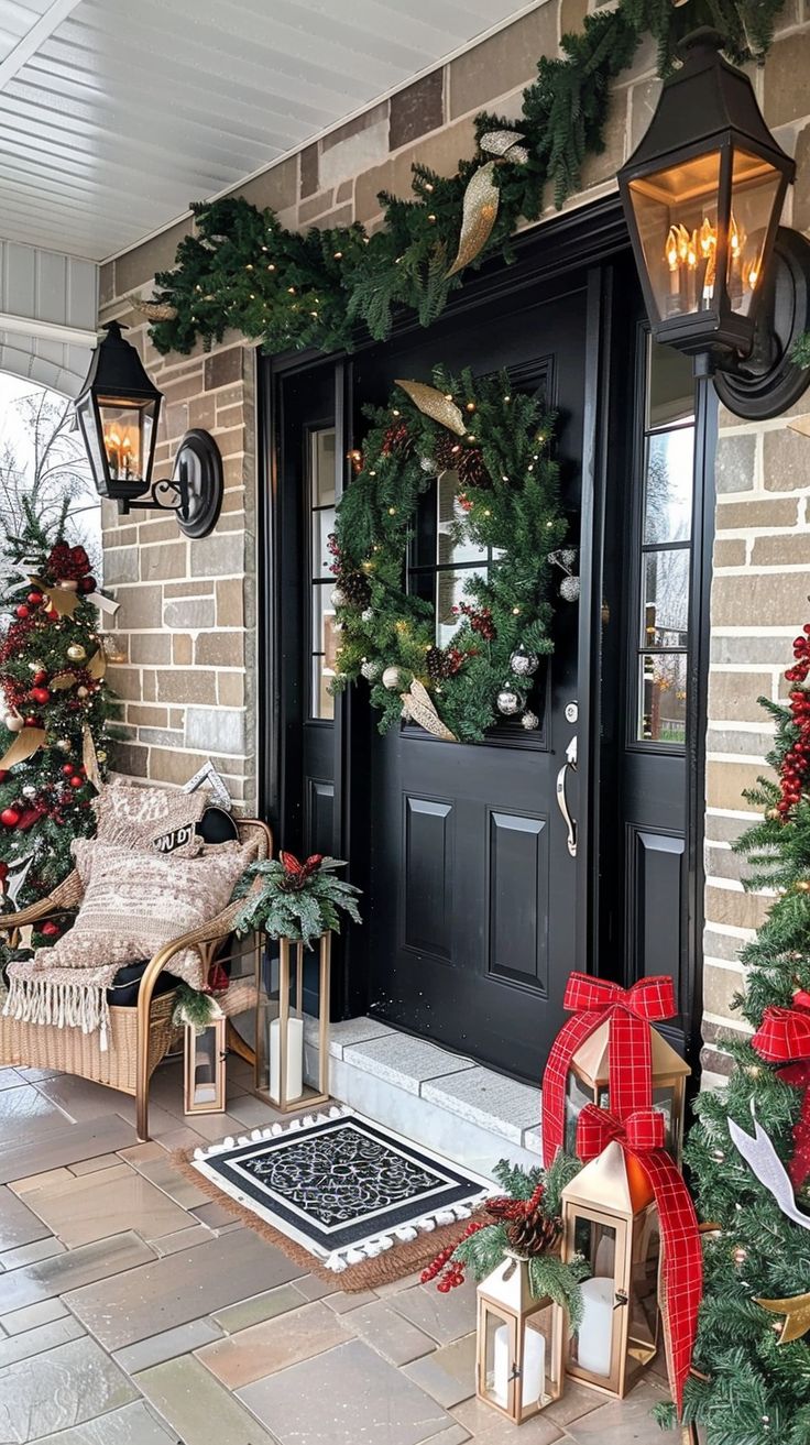 a front porch decorated for christmas with wreaths and lights