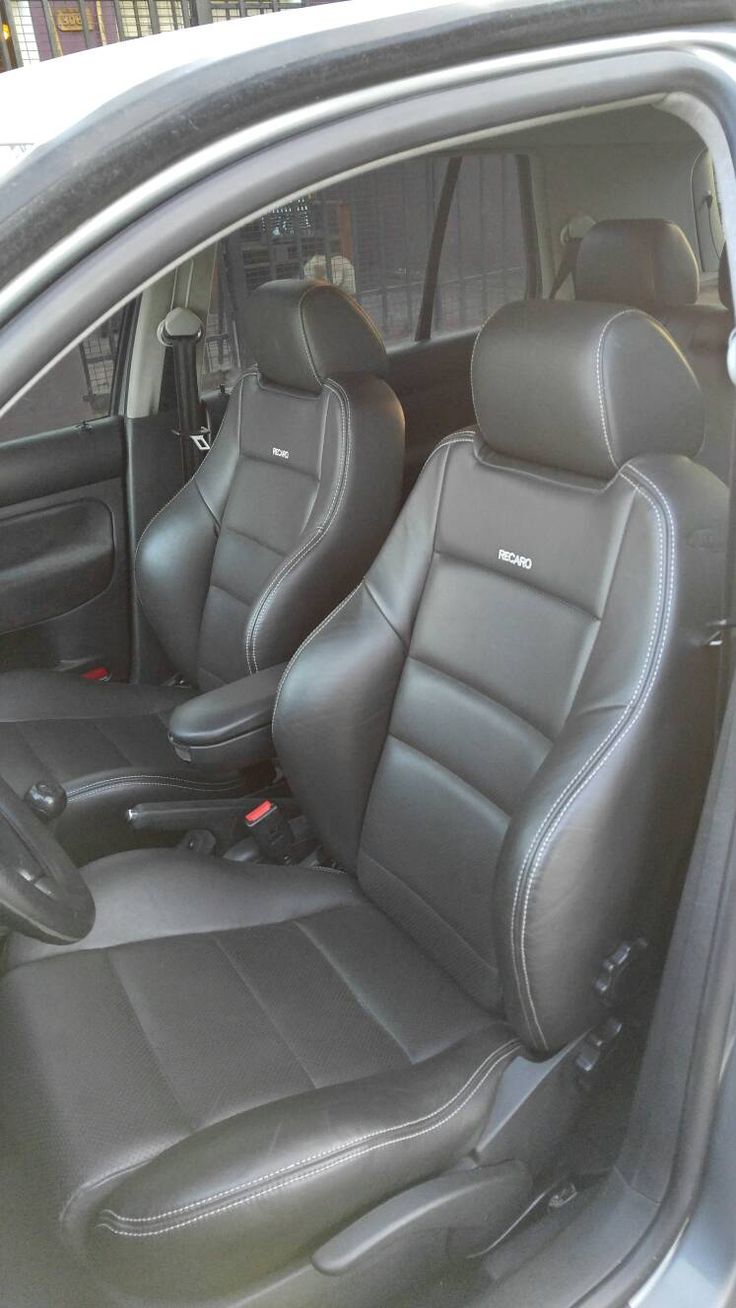 the interior of a car with black leather seats