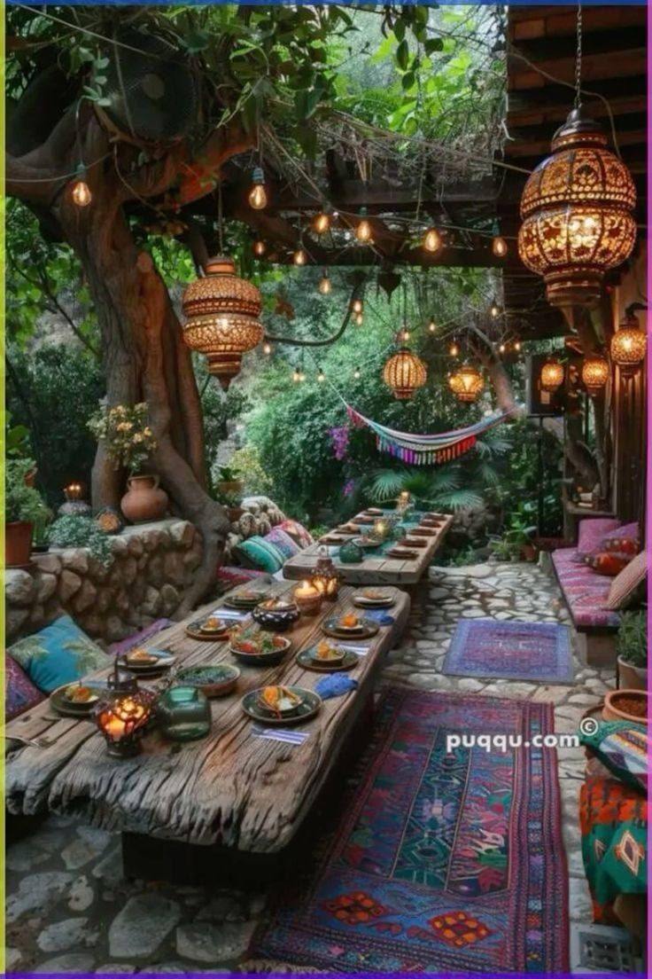 an outdoor dining area with lots of lights and rugs