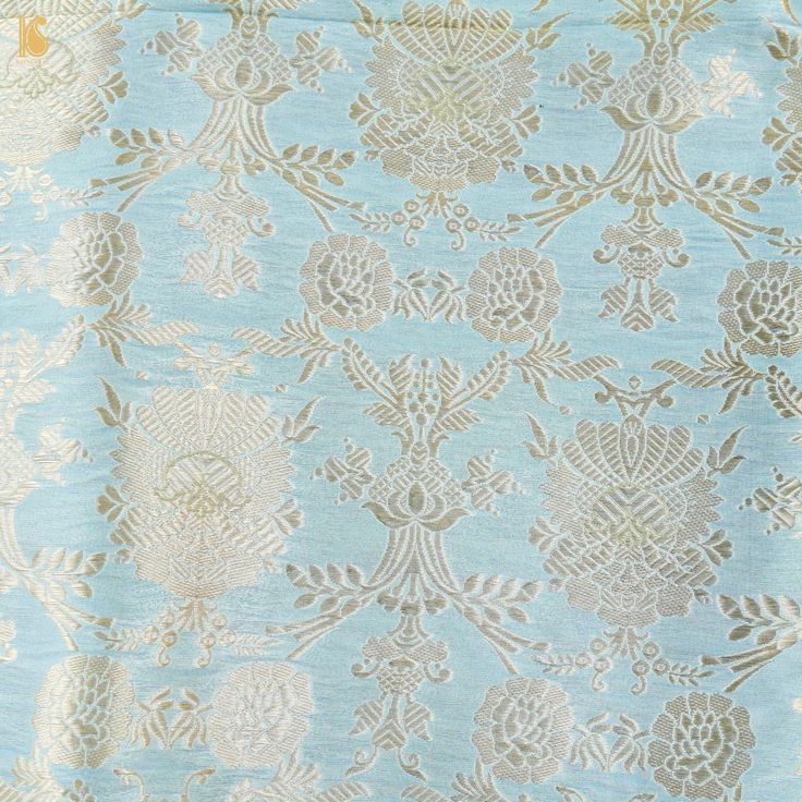 an old blue and gold wallpaper with floral designs on it's edges,