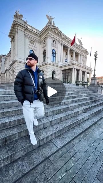 a man standing on some steps in front of a building