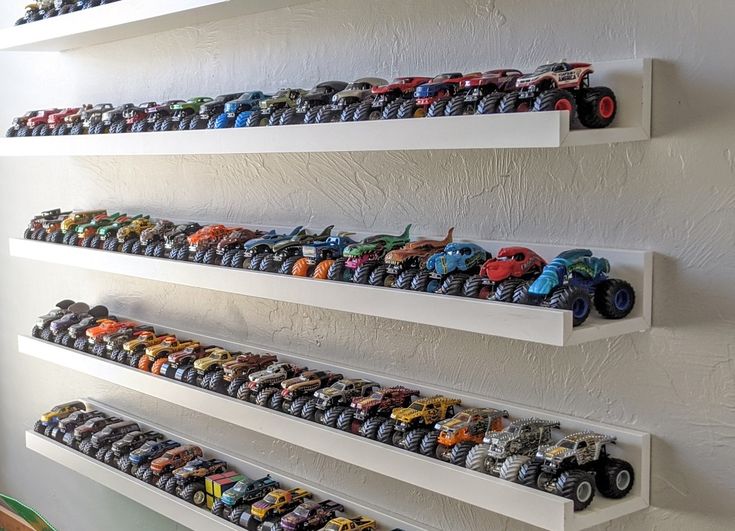 there are many toy trucks on the shelves