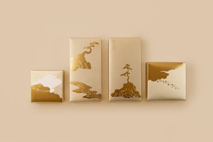 three boxes with designs on them sitting next to each other in front of a beige wall